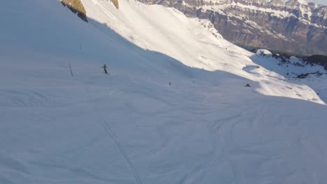 high speed aerial fpv flight down a ski slope in the snowy swiss mountain, race