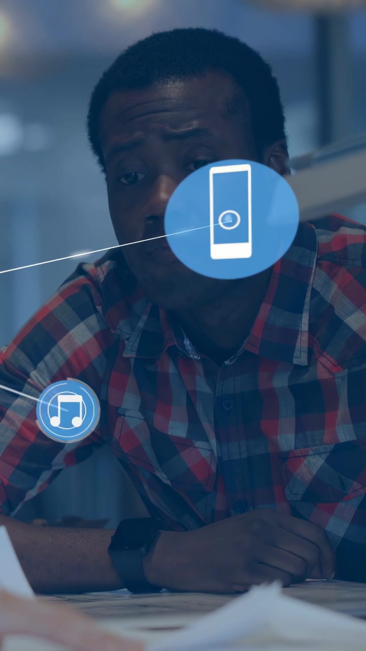 Vertical video: Man reading papers peer placing tablet growing blue phone music tech net for review