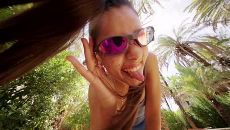 playful moments: young woman's outdoor fun among palm trees