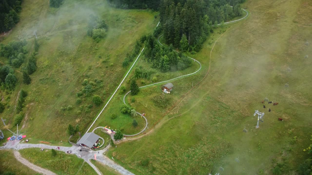 Aerial footage rotating to show an alpine coaster track in the Southern France