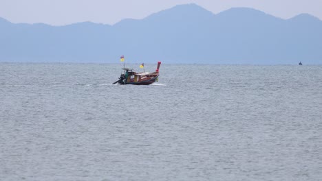 a boat travels across calm krabi waters