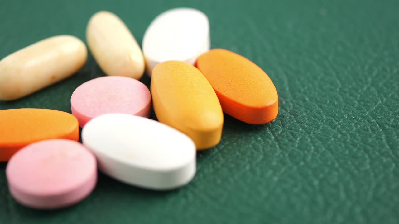 Colorful Pills on a Green Surface