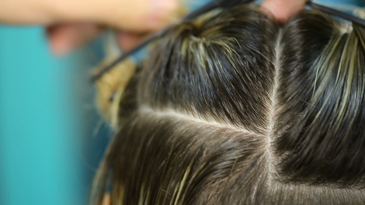 Professional hairdresser cutting hair. Young woman and hairdresser making styling hair at beaty salon
