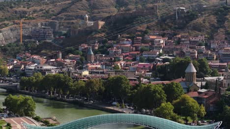 panoramic view of tbilisi, georgia, featuring the bridge of peace and narikala fortress
