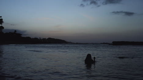 wanderlust concept of woman wading in tranquil ocean water in puerto plata