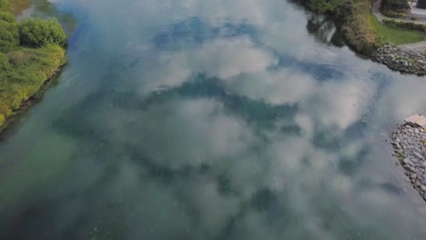 aerial view of clouds reflecting in the waikato river in taupo, new zealand