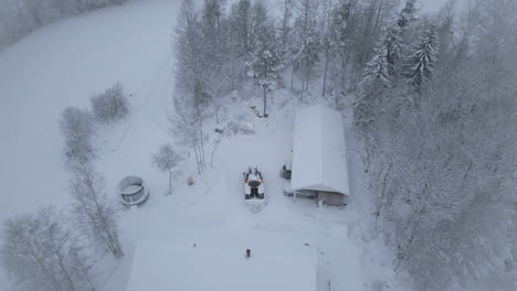 tractor plows snow from private house. aerial circling