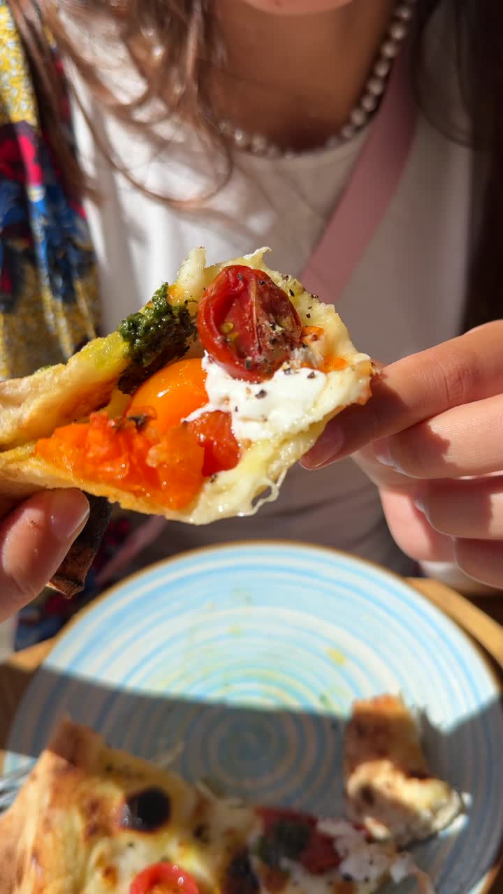 Woman eating a delicious slice of pizza