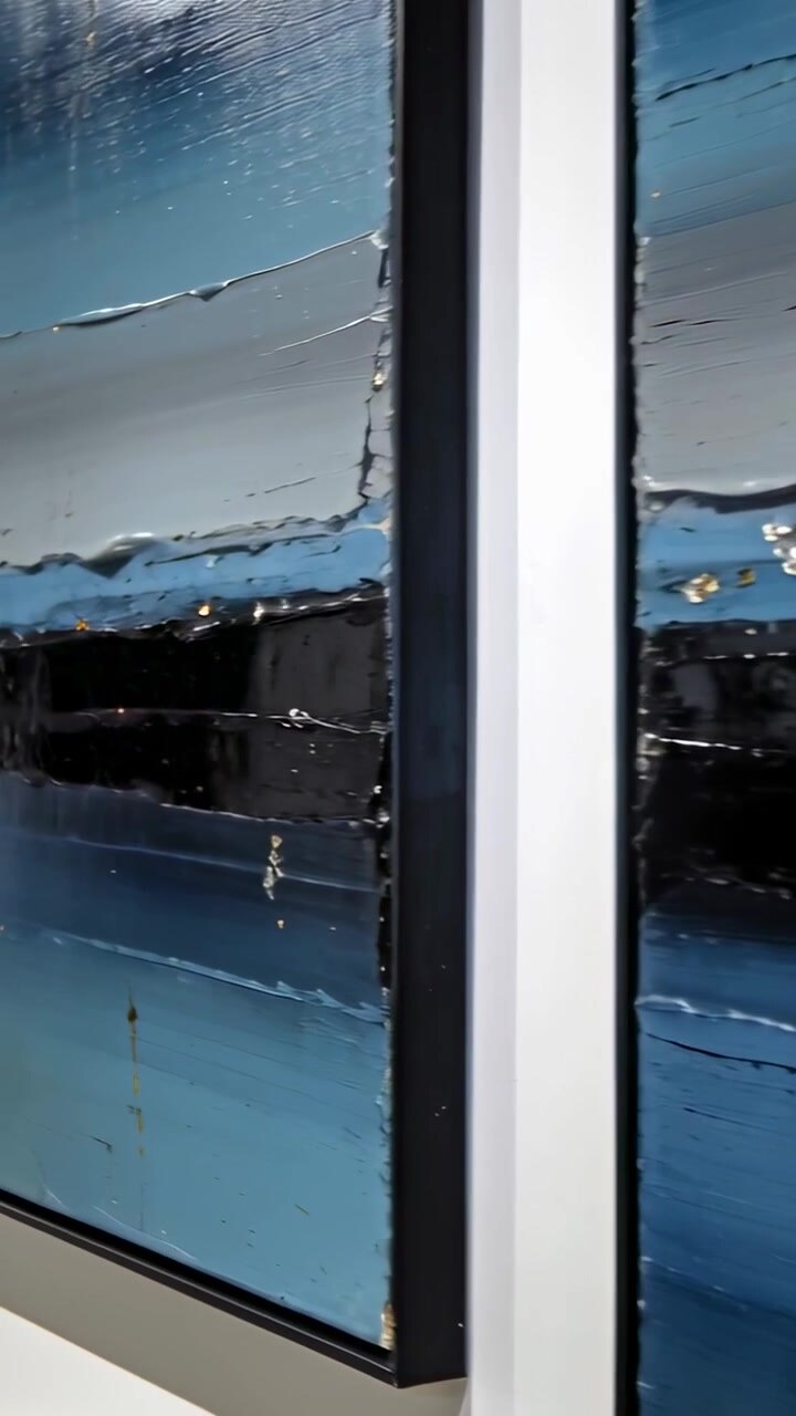 Vertical video: Panning camera from right across framed pair on white wall showing impasto and gold