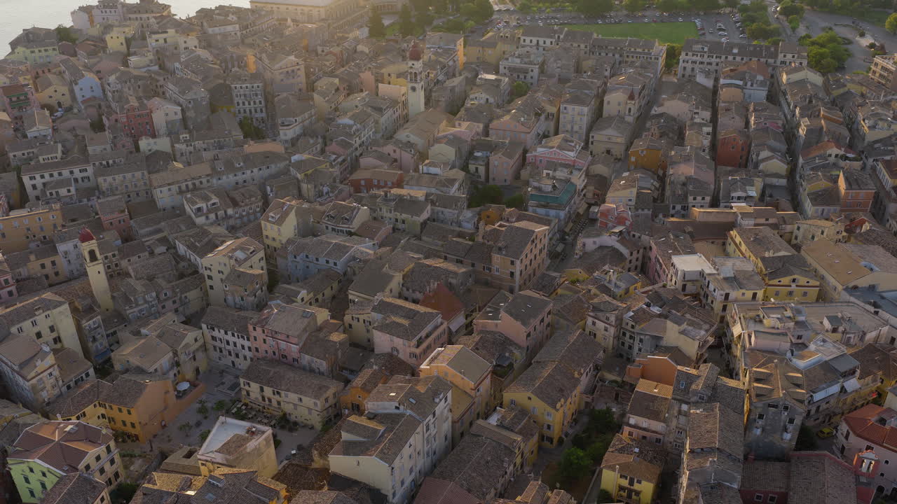 Old Corfu town houses, red tiled roofs at sunrise, drone shot