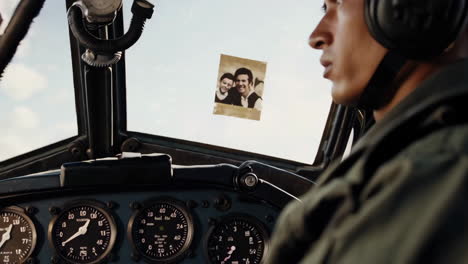 pilot in cockpit with photo