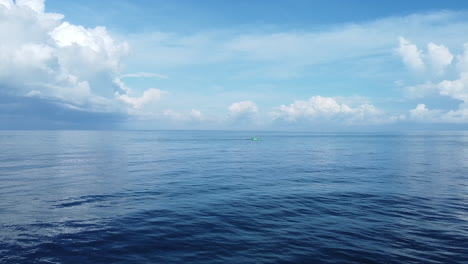 discover the tranquility of the open sea with our stunning footage of a fisherman in an old turquoise boat