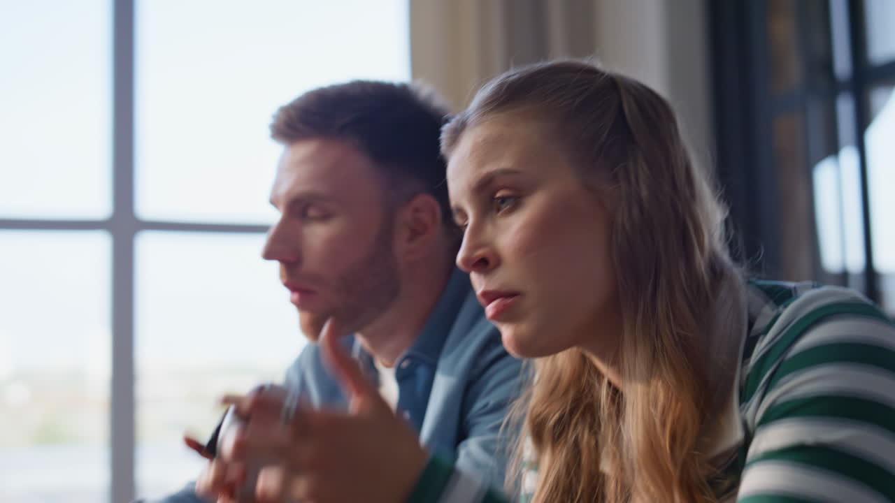 Couple hands play console enjoying online game at home closeup. Pair losing