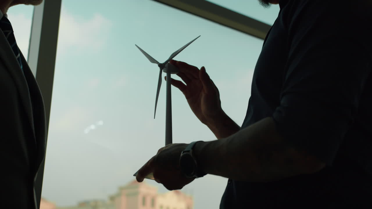 Hands of Entrepreneurs Discussing Implementation of Wind Power at Mockup