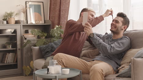young man applying mask on his boyfriend face