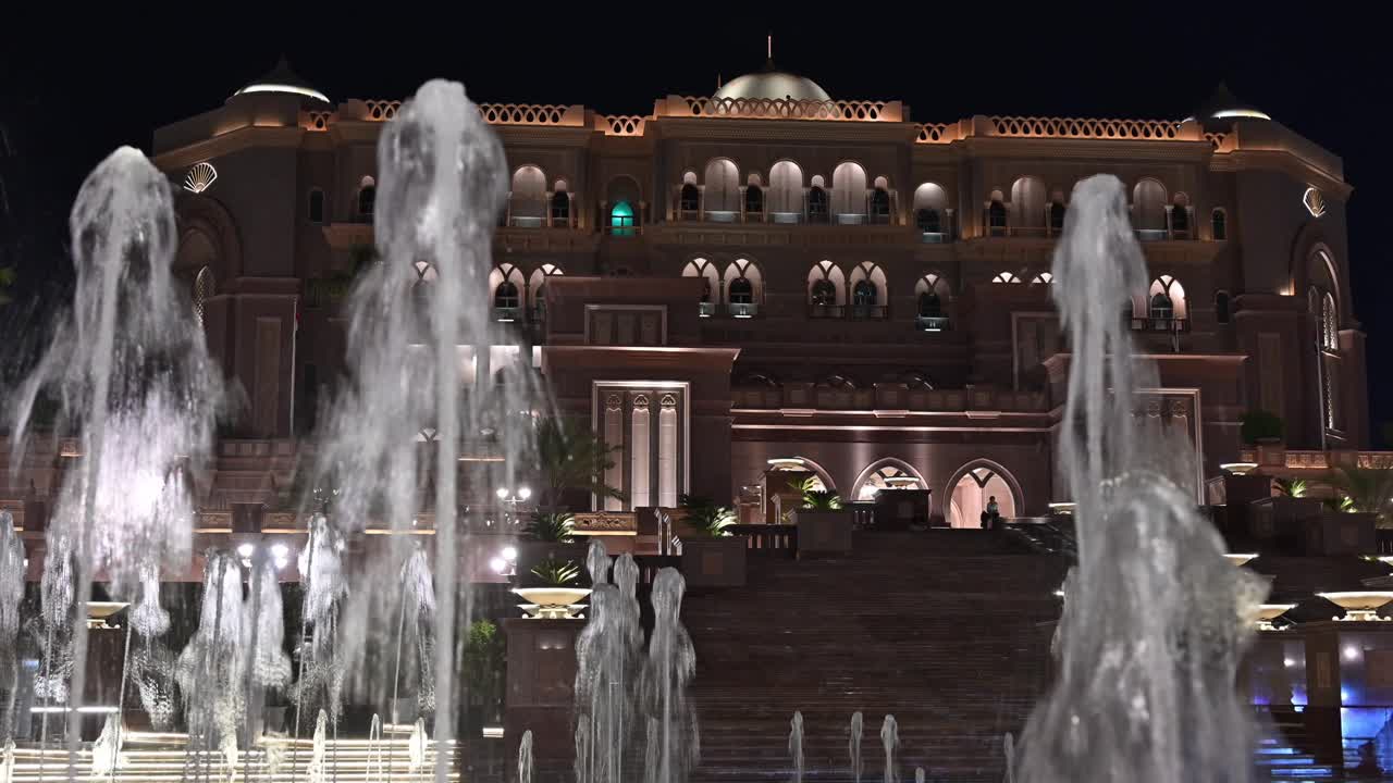 Emirates Palace Hotel lights up the Abu Dhabi skyline at night in the UAE