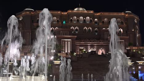 emirates palace hotel lights up the abu dhabi skyline at night in the uae