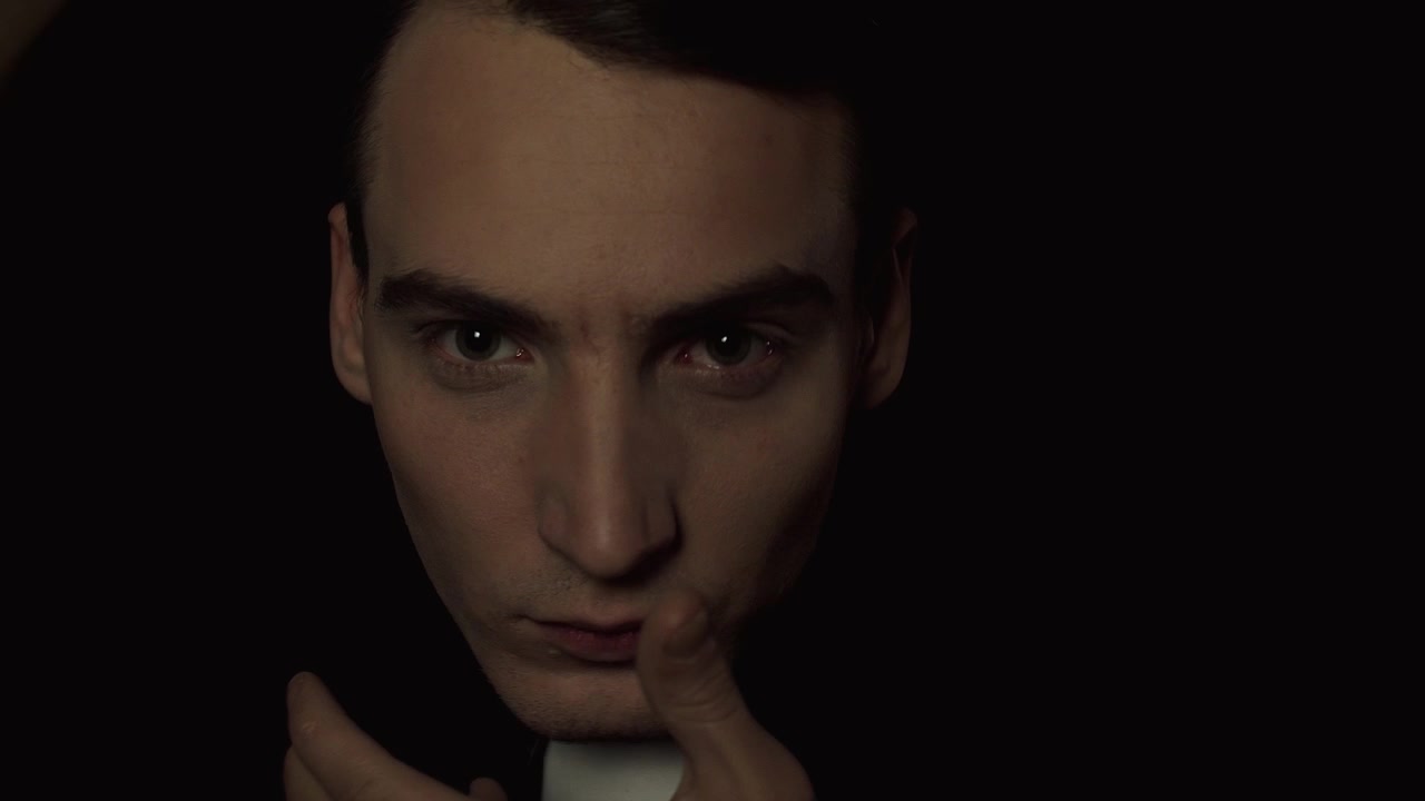 Close-up of a Young Man Posing with Hands Near Face