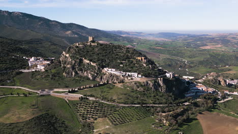 Aerial Drone pushes in on the Zahara de la Sierra Castle on top of a hill. Beautiful historic landmark.