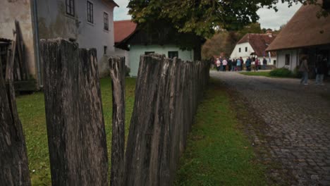 rustic wooden fence along a cobblestone path in a traditional croatian village scene
