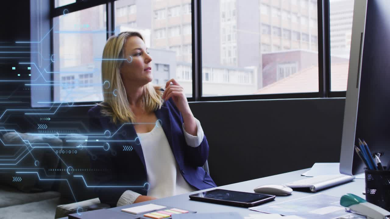 Office woman typing at desk, causing tech overlay left, pausing, holding stylus, gazing, planning