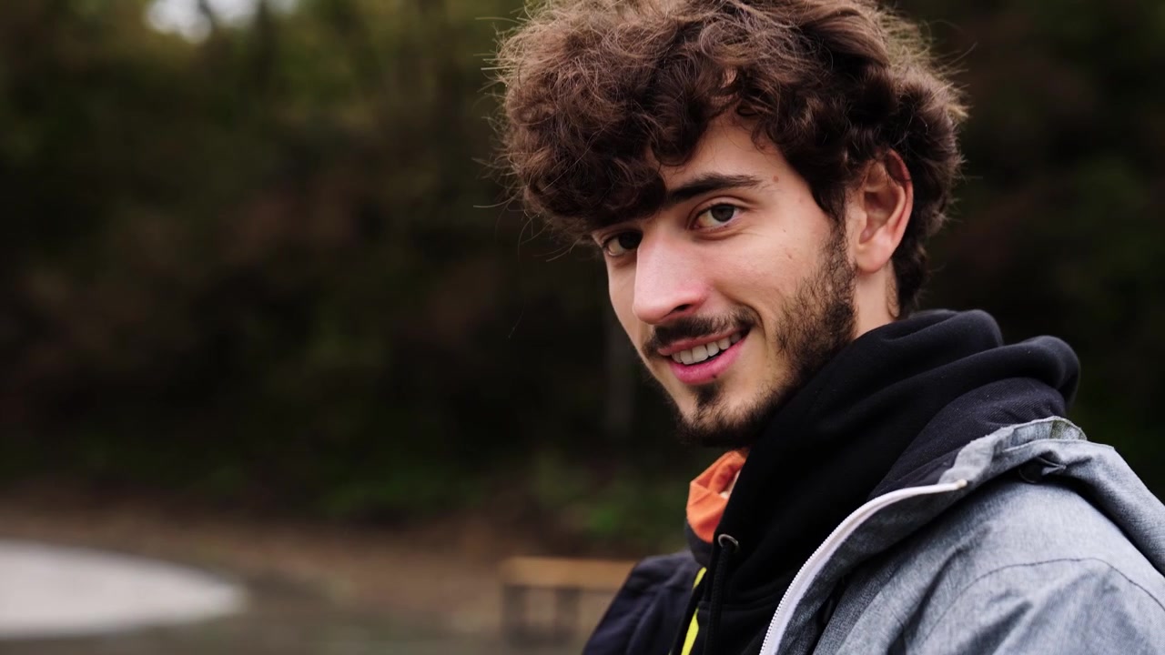 Smiling male with curly hair and beard use drone remote control, Czechia