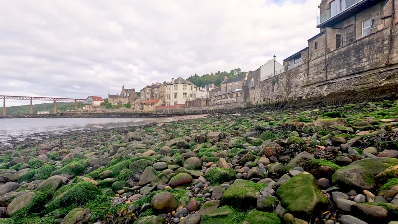 Moss-covered rocks along a coastal town