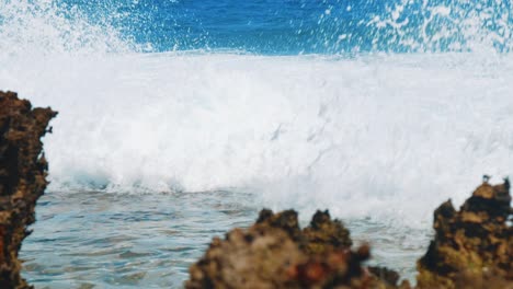 caribbean waves crashing dramatically spraying white foam, slow motion