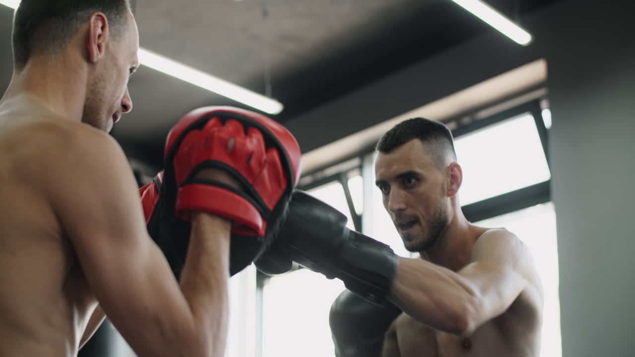 Two Men Boxing in a Gym