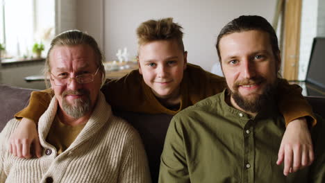 caucasian men sitting on sofa