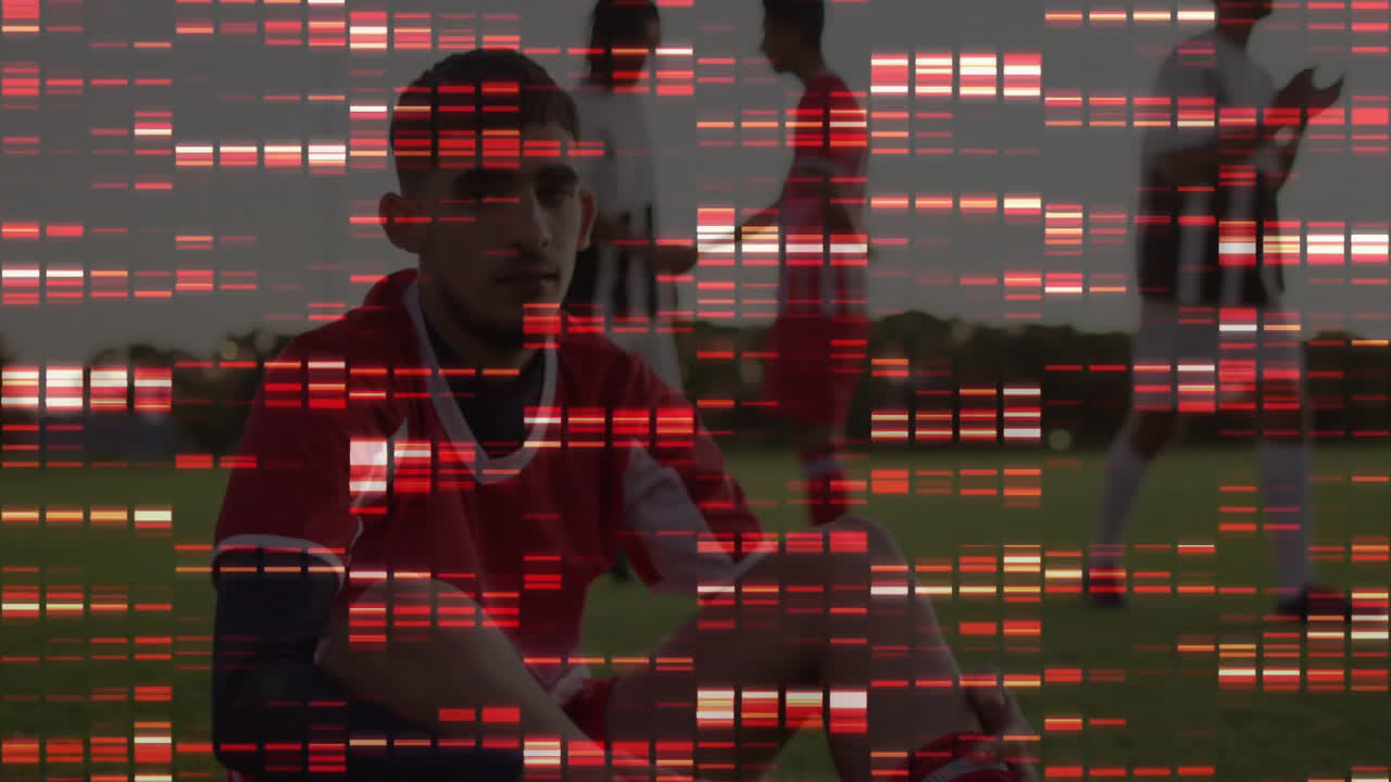 Soccer player sitting on grass field, with digital glitch bars overlay highlighting team sports