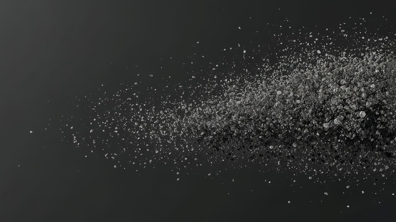 Emerging particle cluster forming drop shape, sliding left, thinning into mist in void, copy space