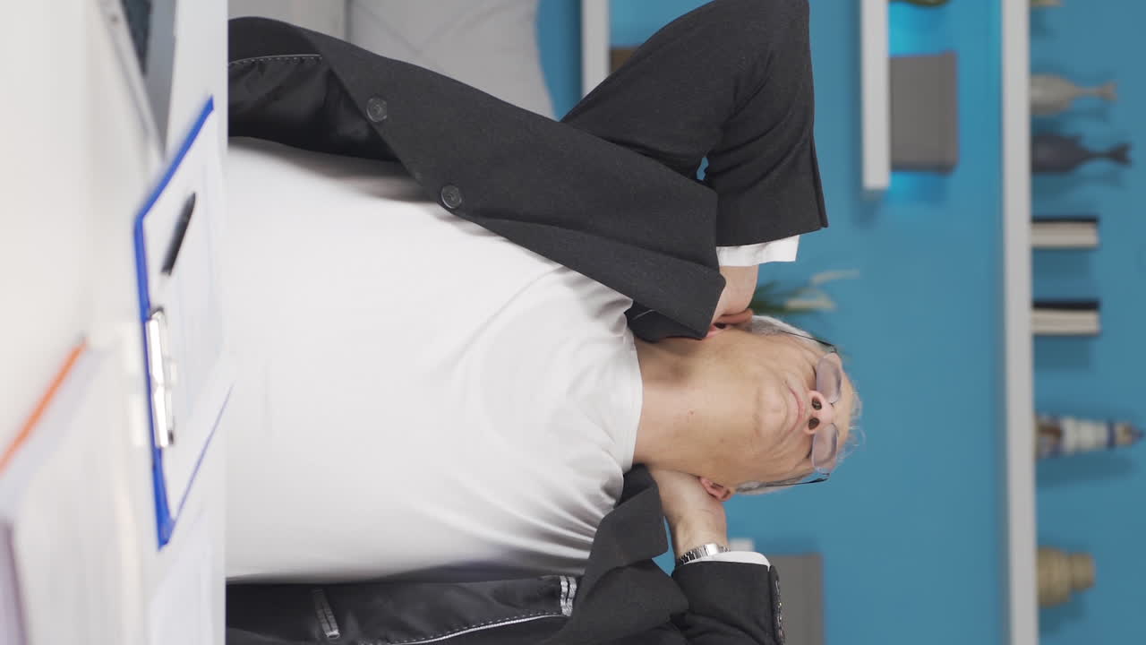 vídeo vertical de un trabajador de oficina en casa que completa su trabajo y se relaja.