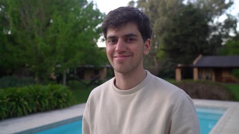 cheerful young man near swimming pool outdoor