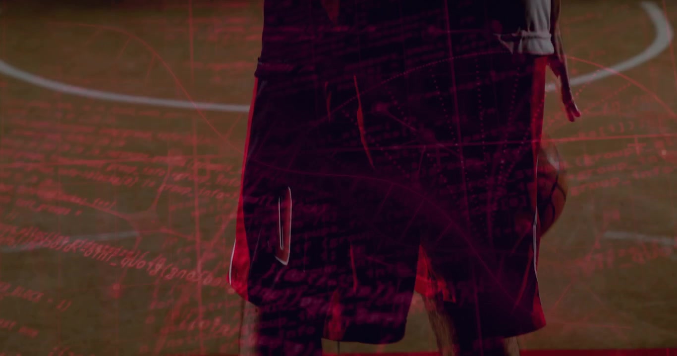 Basketball player bringing ball to hip, settling stance as ball appearing, red overlay across court