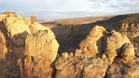 aerial view of colorado butte at sunset with drone video going near rocks