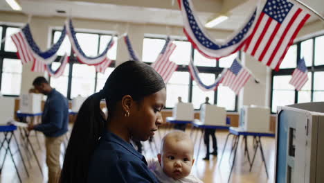 woman with baby voting at a polling place