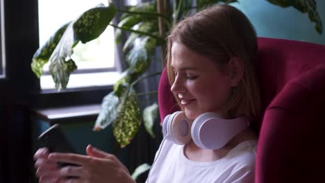 girl relaxing in armchair while listening music
