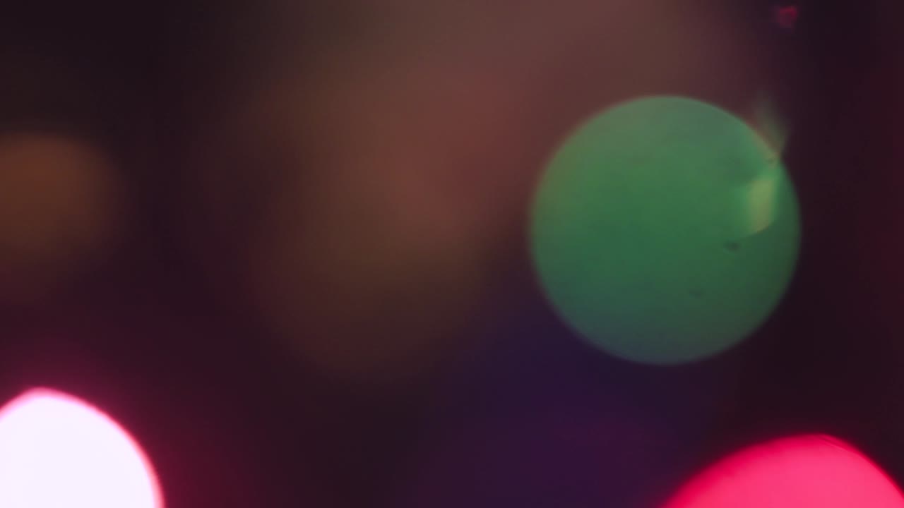 Out of focus Christmas colored lights flicker and move fabulously.