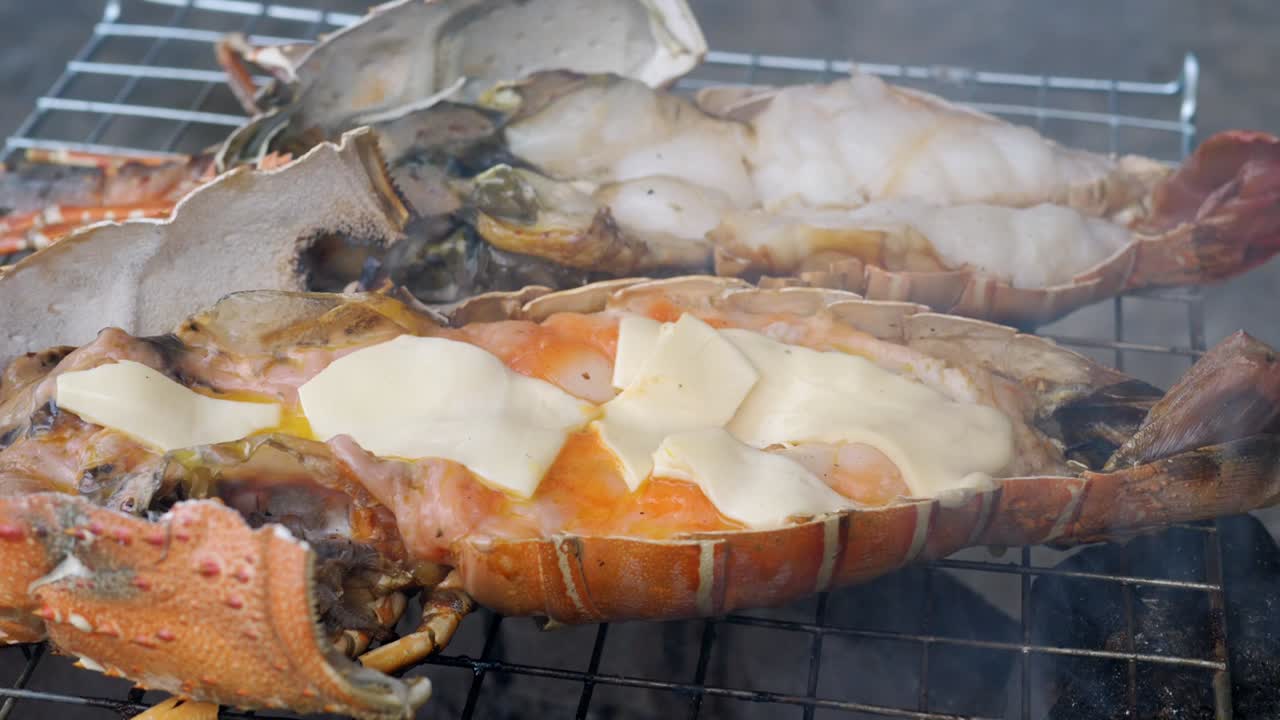 Grilling open lobster on barbecue with smoke and flames - Thailand street food