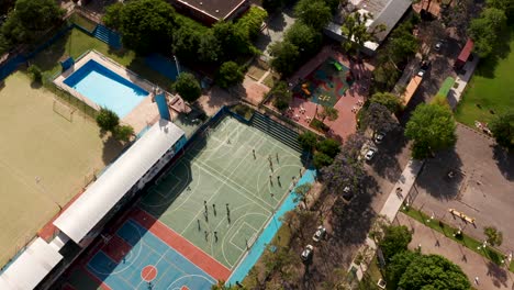 Athletic-People-Playing-Basketball-And-Football-In-Recreational-Area-Under-The-Sunlight