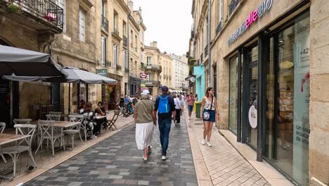 people walking along a bustling street in bordeaux