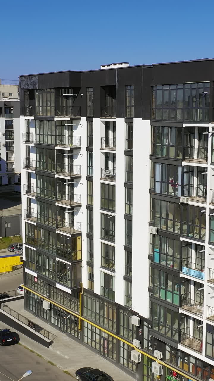 Modern residental apartments exterior. Drone view of new building townhouses. Vertical video