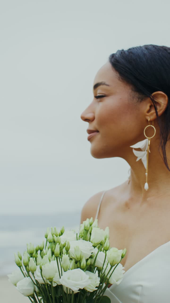 Bridal portrait with white bouquet and elegant earrings