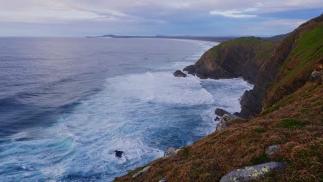 white foamy waves splashing on the rocky cliffs - crescent head - surfing paradise in sydney, nsw, australia