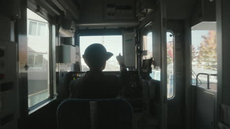 Backview-Of-A-Woman-Train-Conductor-Driving-On-Cockpit-In-Sendai,-Japan