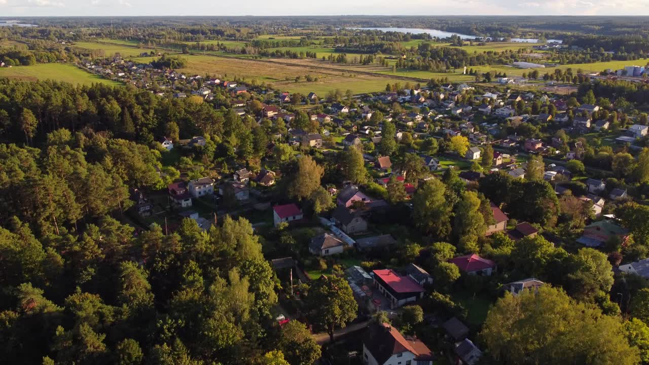 Aerial view of small town surrounded by forest and fields in Ogre, Latvia