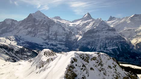 clockwise-orbit-around-a-snowboarder-on-a-snowy-mountain-top-in-Swiss-Alps