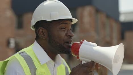 construction worker using a megaphone on a construction site