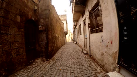 ancient paved street barred window old and modern doors in sanliurfa